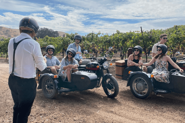 a group of people standing around a motorcycle