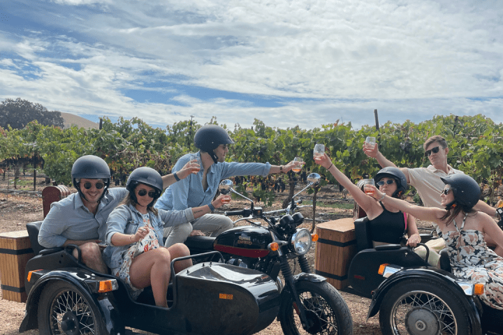 a group of people sitting on a motorcycle