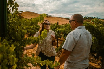 a couple enjoys their vineyard tour in Paso Robles wine country