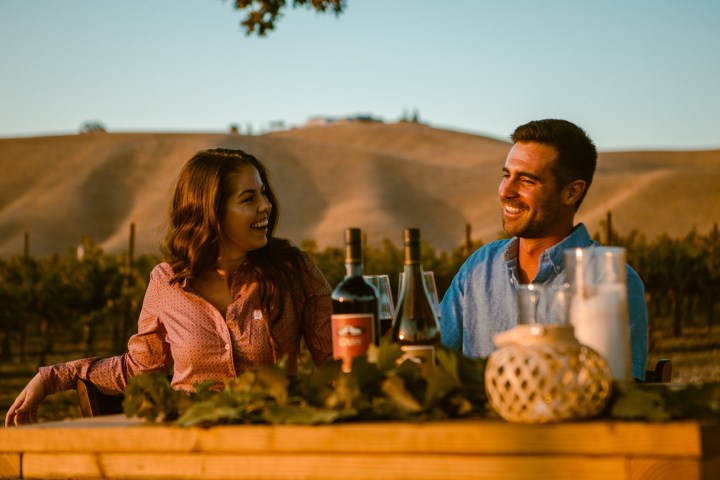 a couple enjoying their date night and picnic on the vineyard in Wine Country After Hours